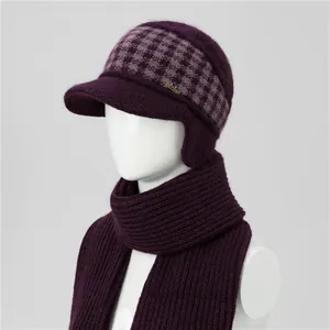 Detail of warm purple knit winter hat and scarf set with fleece lining for older women