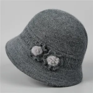 Detail of dark grey knit bucket hat featuring soft wool texture and floral accents