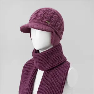 Detail of purple winter knit hat and scarf set with ear protection and cable pattern