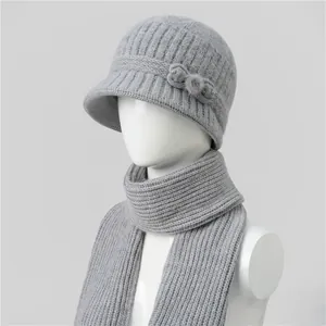 Detail of grey knitted hat with bow and pearl decor on a white mannequin head