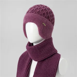 Detail of purple knitted hat and scarf set with ear protection and honeycomb texture