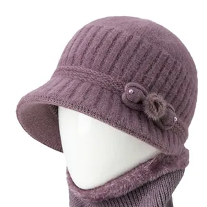 Purple knit winter hat and scarf set for elderly women featuring fur lining and bow detail