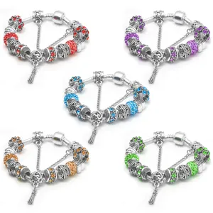 Close-up of five colorful crystal bead bracelets with floral charms and safety chains