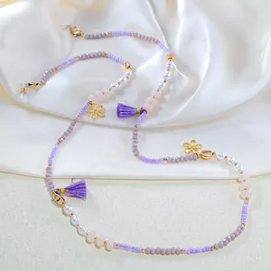 Detail of colorful beads, pearl eyewear chain with flower charms and silk tassels