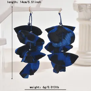 Detail view of long blue leopard print fabric petal earrings with size and weight info