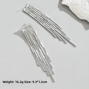 Detail of silver long tassel earrings with sparkling rhinestones showing 9.3cm length