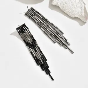 Detailed view of gunmetal long tassel earrings with shimmering black rhinestones