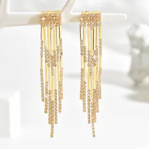 Detail of elegant gold waterfall tassel earrings with cascading crystal rhinestones