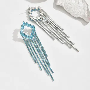 Detailed view of silver tassel earrings with sky blue rhinestones and metal back structure