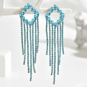 Detail of light blue crystal tassel earrings with sparkling rhinestones and silver finish