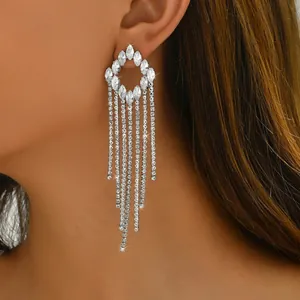 Close-up of sparkling silver tassel earrings with marquise-cut rhinestones and long fringe