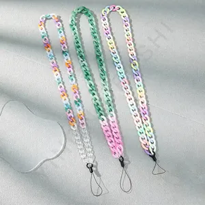Colorful acrylic chain phone lanyards in transparent and macaron tones on stone background