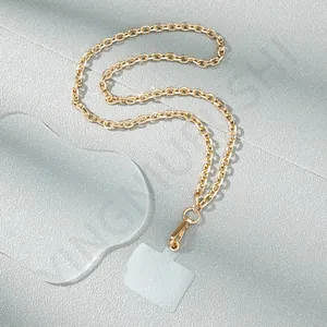 Detail of golden metal chain phone strap with lobster clasp and clear PVC gasket