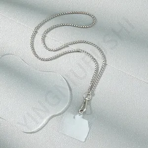 Detail of silver box chain phone strap with lobster clasp and clear gasket insert