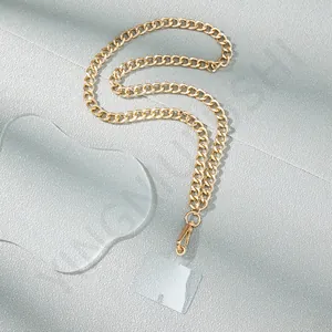 Detail of a golden metal Cuban chain phone strap with transparent connector and lobster clasp