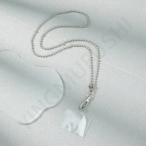 Detail view of silver metal ball chain for phone with clear PVC connector and lobster clasp