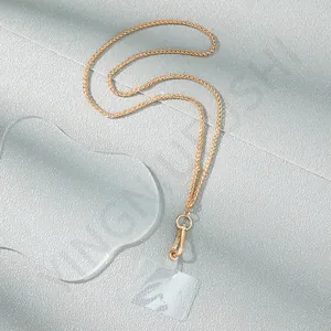Macro detail of golden metal phone chain with spring clasp and transparent insert