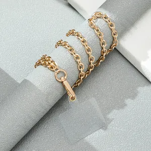 Detailed view of a golden metal link phone chain with a transparent securing pad