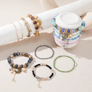 Detail view of multi-layer Bohemian beaded bracelet sets with moon and star charms