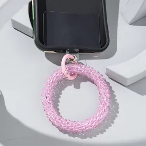 Close-up of pink translucent beaded phone lanyard with a metal spring ring clasp