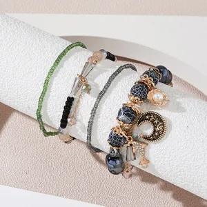 Detail view of Bohemian multi-layer beaded bracelets with moon and shell charms on display