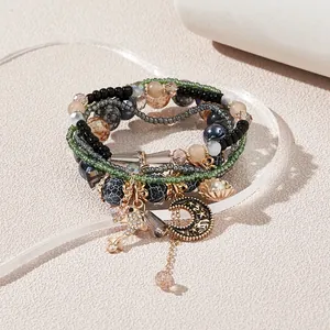 Macro view of multi-layered bohemian beaded bracelet with star and shell charms