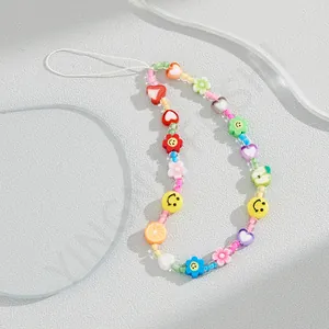 Close-up of colorful acrylic beaded phone strap with smiley faces and fruit charms