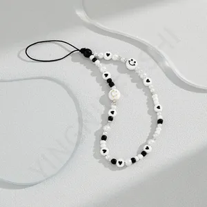 Minimalist macaron acrylic phone strap with black and white beads and smiley face charms