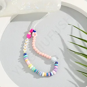 Macaron beaded phone strap with LOVE letters, evil eye, and transparent bow charm