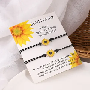 Detail of two woven sunflower bracelets on a gift card with a warm aesthetic background