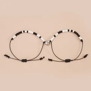 Magnetic heart couple bracelets with adjustable black cords and black white seed beads