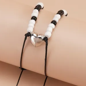 Magnetic heart bracelets with black and white beads and adjustable woven rope