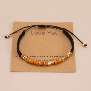 Detail of Morse Code handmade bracelet with wood beads on I Love You gift card