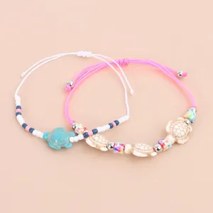 Set of two bohemian turtle charm bracelets with colorful beads and woven wax ropes