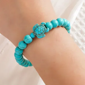 Turkooizen kralenarmband met zeeschildpad bedel en natuurlijke bruine aderpatronen