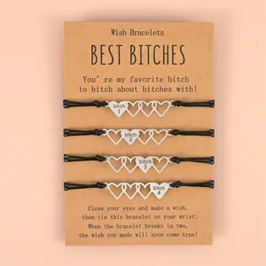 Close-up of four-piece sister wish bracelets with heart charms on display card
