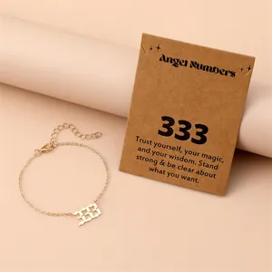 Close-up of gold stainless steel angel number 333 pendant with lobster clasp chain