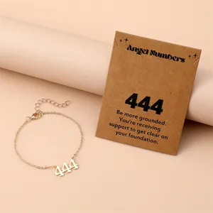 Detail of gold angel number 444 bracelet with card showing symbolic meanings
