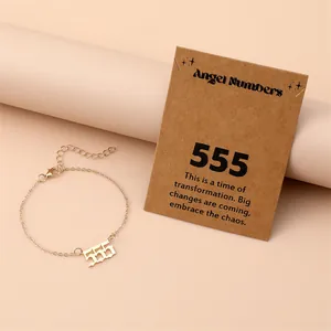 Detail of gold angel number 555 bracelet with lobster clasp and original card packaging
