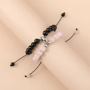 Magnetic heart couple bracelets with black and pink beads on adjustable cords