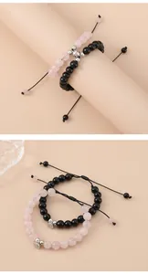 Macro shot of magnetic heart couple bracelets with pink crystal and black beads