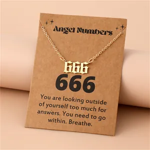 Macro view of gold 666 angel number pendant with gothic font on brown display card
