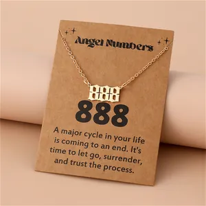 Detailed view of golden 888 angel number pendant on a decorative kraft paper card
