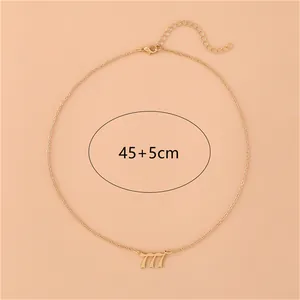Gold stainless steel angel number 777 pendant necklace with adjustable chain on pink background