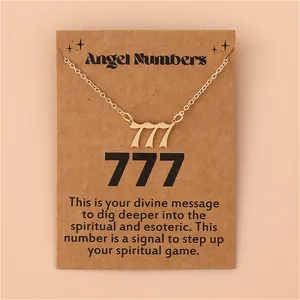 Detail of gold angel number 777 pendant necklace on an informative kraft paper card