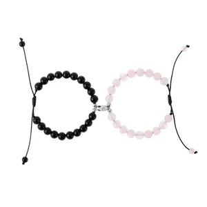 Adjustable magnetic heart couple bracelets with black and pink crystal beads on white background