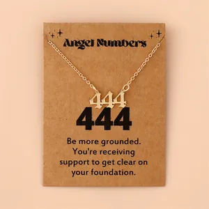 Detail of gold 444 angel number pendant with Gothic font on brown kraft gift card