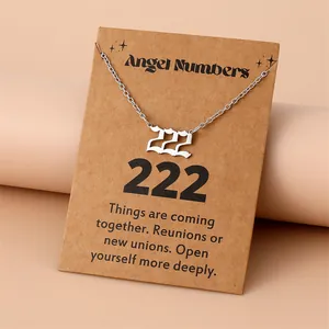 Gros plan du pendentif chiffre ange 222 en argent sur une carte de message décorative