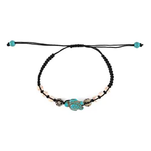 Bohemian turtle bracelet with turquoise charm and white beads on black woven rope cord