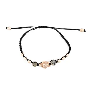 Bohemian braided turtle bracelet with turquoise beads on a white background